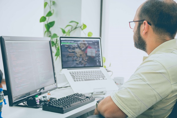 man working with laptops on a business computer network