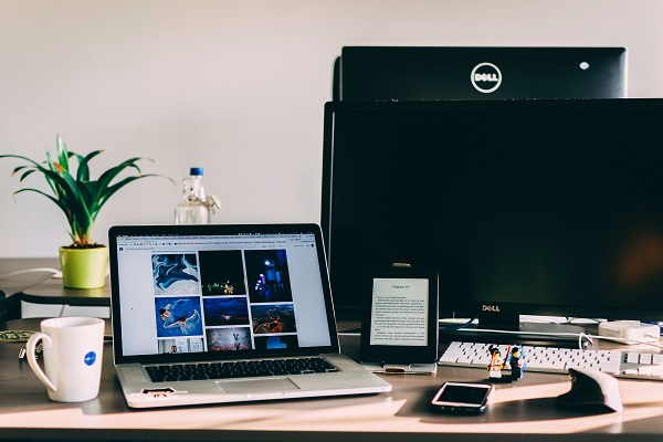 desk with computers on a cloud network